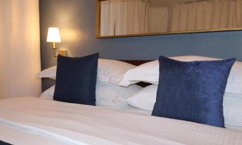 a bedroom with a bed with blue pillows at Hotel Downtown-Miami SQR in Miami