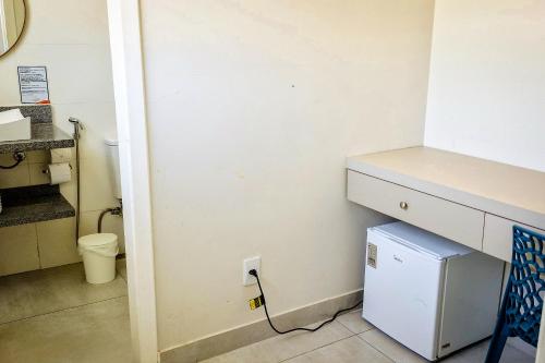 a bathroom with a counter and a sink and a toilet at VELINN Pousada Angra Sunset in Angra dos Reis