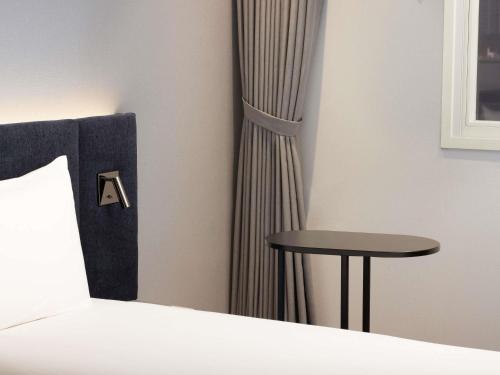 Ένα ή περισσότερα κρεβάτια σε δωμάτιο στο ibis Ambassador Seoul Insadong-Newly renovated in 2025