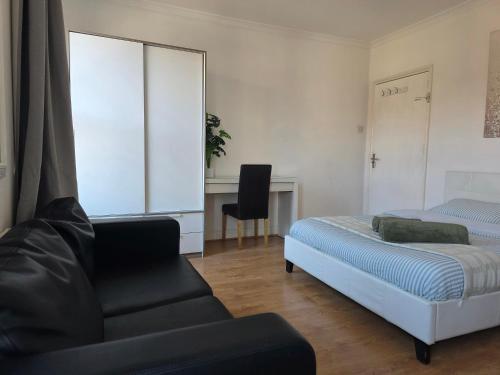 a bedroom with a bed and a couch and a desk at Studios & Ensuite Doubles - Central RG1 - Oracle - Station & Hospital in Reading