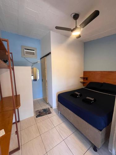 a bedroom with a bed and a ceiling fan at Pousada Catavento in São Gonçalo do Amarante