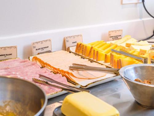 a counter with different types of meats and cheese at ibis Styles Tours Centre in Tours