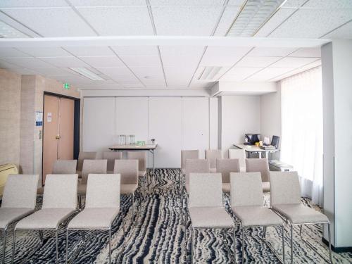 an empty waiting room with chairs and a table at ibis Styles Tours Centre in Tours