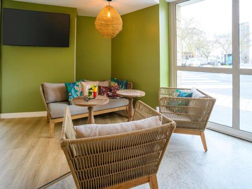 a living room with a couch and a table and chairs at ibis Styles Tours Centre in Tours