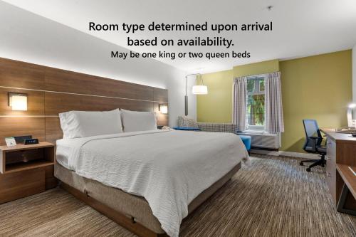 a hotel room with a bed and a desk at Holiday Inn Express and Suites Surrey by IHG in Surrey