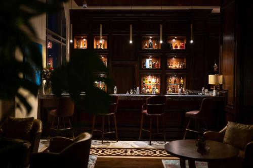 a bar at a restaurant with chairs and a table at The St. Regis Marsa Arabia Island, The Pearl Qatar in Doha