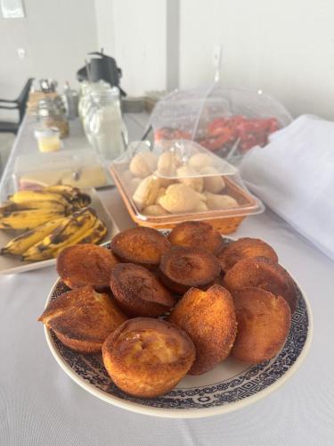 a plate of donuts sitting on a table at Pousada Canta Galo in Goiás