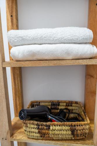 a shelf with towels and a basket with a bike at Mintaka Boutique Hotel in Bwejuu