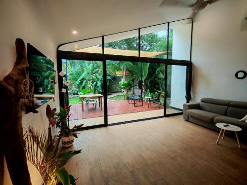 a living room with a couch and a glass door at Pyramid Tamarindo Luxury Hotel in Tamarindo