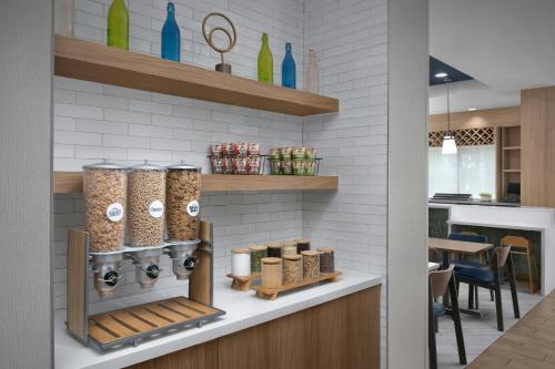 a kitchen with a counter with a bunch of spices at Fairfield Inn & Suites Fort Lauderdale Airport & Cruise Port in Dania Beach
