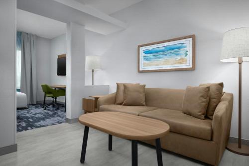 a living room with a couch and a table at Fairfield Inn & Suites Fort Lauderdale Airport & Cruise Port in Dania Beach