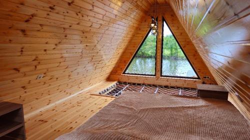 une petite chambre avec une fenêtre dans une cabane en bois dans l'établissement Kolkheti Eco Cottages livlivi ლივლივი - small cottage, à Poti