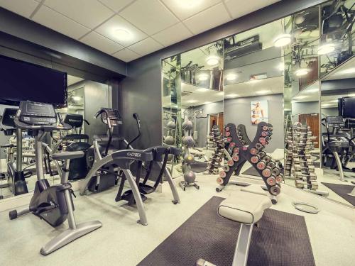 a gym with several treadmills and exercise equipment at Mercure Nottingham City Centre Hotel in Nottingham