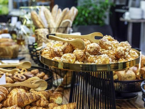 a display of pastries and breads in a bakery at Mercure Nottingham City Centre Hotel in Nottingham