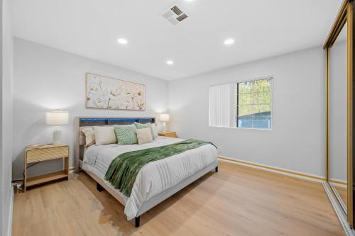 a white bedroom with a bed and a window at Entire Private 4BR 2Bth, Pool, View, 4 Parking, King Bed, Big Yard in El Cajon