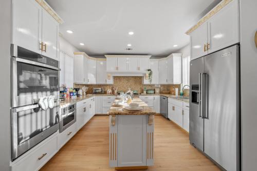 a kitchen with white cabinets and stainless steel appliances at Entire Private 4BR 2Bth, Pool, View, 4 Parking, King Bed, Big Yard in El Cajon