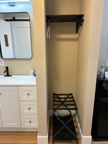 a bathroom with a white sink and a mirror at Mainstay Inn in Phoenixville
