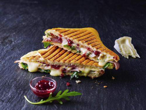 a sandwich cut in half sitting on top of a table at ibis München City Süd in Munich