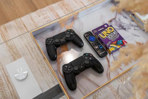 two video game controllers and a snack on a table at Entire Private 4BR 2Bth, Pool, View, 4 Parking, King Bed, Big Yard in El Cajon