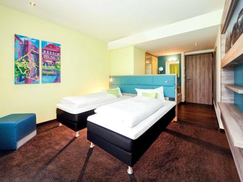 Una cama o camas en una habitación de ibis Styles Nagold-Schwarzwald
