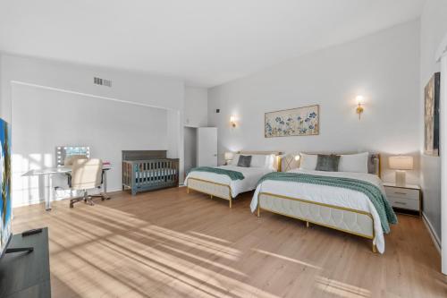 a white bedroom with two beds and a desk at Entire Private 4BR 2Bth, Pool, View, 4 Parking, King Bed, Big Yard in El Cajon