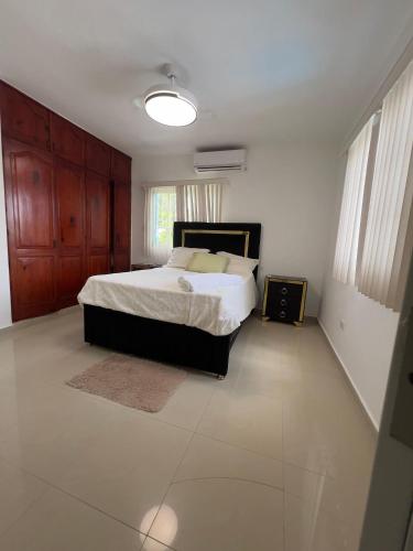 a bedroom with a large bed in a room at villa costeña piscina privada in San Felipe de Puerto Plata