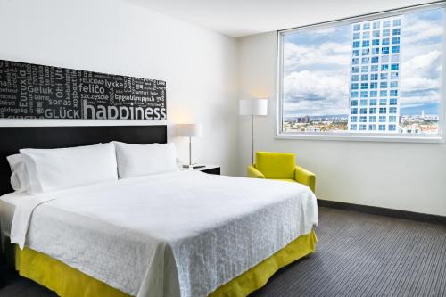 a hotel room with a bed and a window at Holiday Inn Express & Suites Puebla Angelopolis by IHG in Puebla