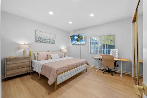 a bedroom with a bed and a desk in it at Entire Private 4BR 2Bth, Pool, View, 4 Parking, King Bed, Big Yard in El Cajon