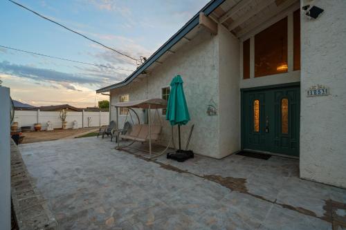 a patio with a green door and an umbrella at Entire Private 4BR 2Bth, Pool, View, 4 Parking, King Bed, Big Yard in El Cajon