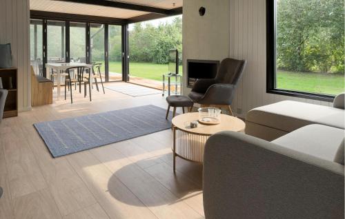 a living room with a couch and a table at 3 Bedroom Stunning Home In Grenaa in Grenå