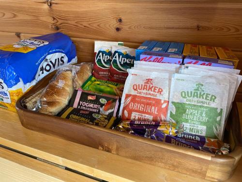a shelf with a bunch of different types of food at SEApods - Isle of Lewis - Luxury en-suite pods on the edge of the Atlantic Ocean in Aird Uig