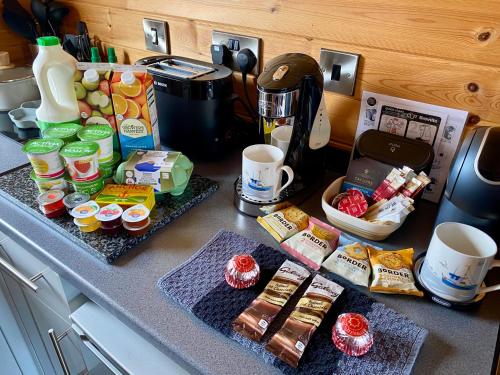 a kitchen counter with breakfast food and coffee on it at SEApods - Isle of Lewis - Luxury en-suite pods on the edge of the Atlantic Ocean in Aird Uig
