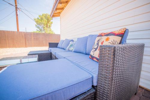 a blue couch and a wicker table on a patio at Remodeled Family Retreat 15ppl in Page