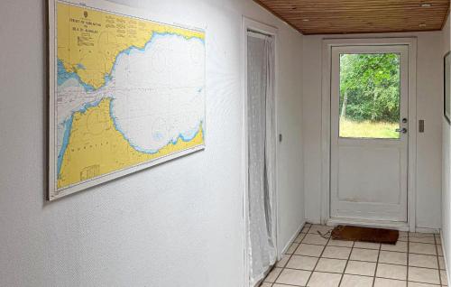 a map hanging on a wall next to a door at Lovely Home In Hundested With Wifi in Kulhuse
