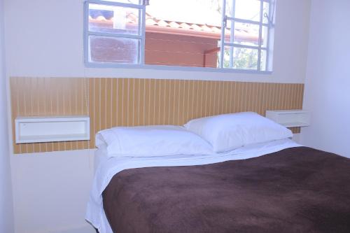 Кровать или кровати в номере HOSTEL da FLORESTA - centro BH