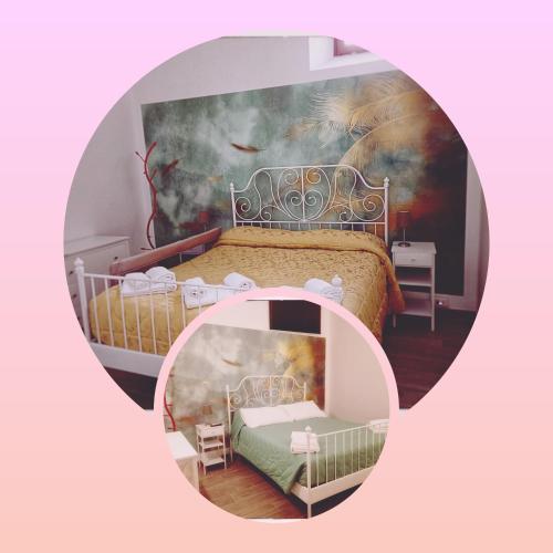 a room with a bed with a painting on the wall at Vagabondando travel house in LʼAquila