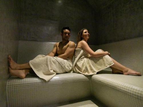a man and a woman sitting on a bed at ibis Styles Zeebrugge in Zeebrugge