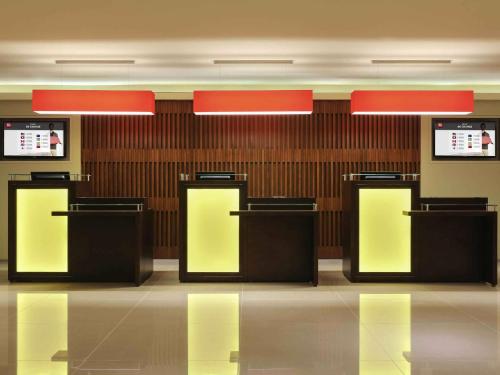 a lobby with four black and yellow detectors at Ibis Riyadh Olaya Street in Riyadh