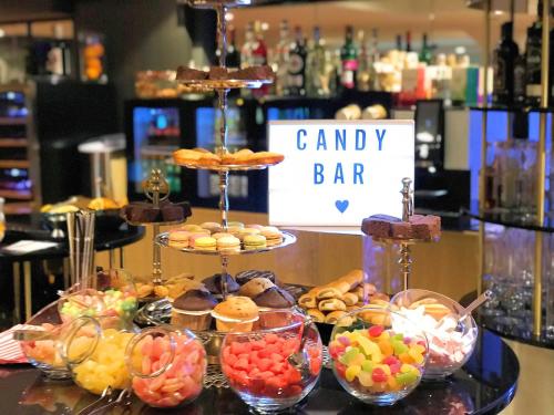 a candy bar with different types of pastries and desserts at Mercure Hotel Kaiserhof City Center in Frankfurt/Main