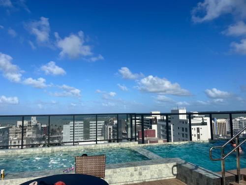 a swimming pool on the roof of a building at Flat no Move em Tambaú in João Pessoa