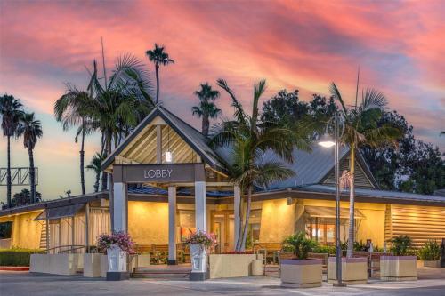 a building with palm trees in front of it at Best Western Seven Seas in San Diego
