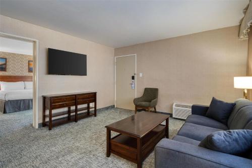 a living room with a couch and a desk and a bed at Best Western Seven Seas in San Diego