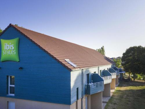 a blue building with a sign on the side of it at ibis Styles Bourbon Lancy in Bourbon-Lancy