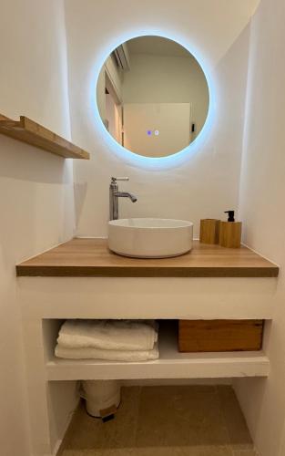 a bathroom with a sink and a mirror at Le Cloître du Palais - Studio in Avignon