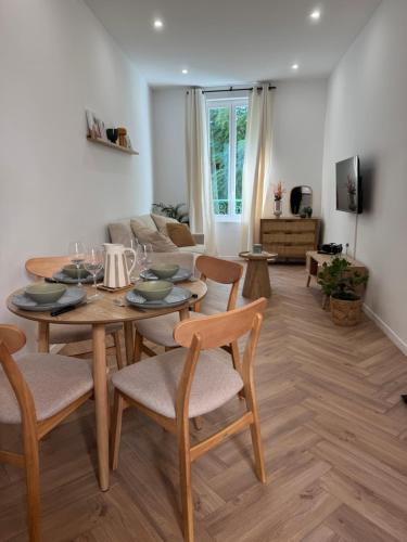 a dining room and living room with a table and chairs at Le Cloître du Palais - Studio in Avignon