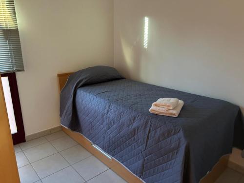 a bedroom with a bed with a towel on it at El Hierro in Frontera