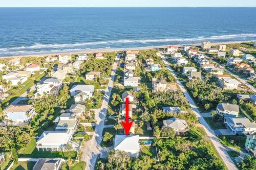 an aerial view of a residential suburb with a red arrow in the middle at Beach Hot Tub & Pool Getaway in Palm Coast walk or bike to the beach in Marineland