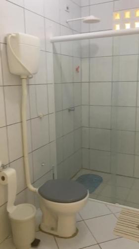 a bathroom with a toilet with a black seat at Casa a beira Mar - Ponta de Mangue - Maragogi in Maragogi