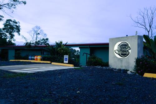 a building with a sign on the side of it at Cabañas Vista Verde opción sin jacuzzi in San Vito