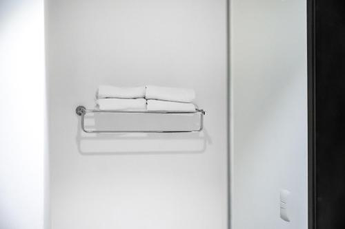 a white door with three towels on it at Holiday Inn Express & Suites Puebla Angelopolis by IHG in Puebla